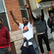 Baltimore residents celebrate at the corner of West North and Pennsylvania avenues after Baltimore authorities released a report on the death of Freddie Gray while police in riot gear stand guard on May 1, 2015.
Win McNamee/Getty Images